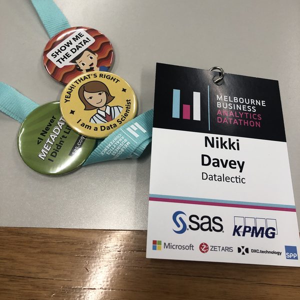 A Melbourne Business Analytics Datathon name badge and data-themed pins