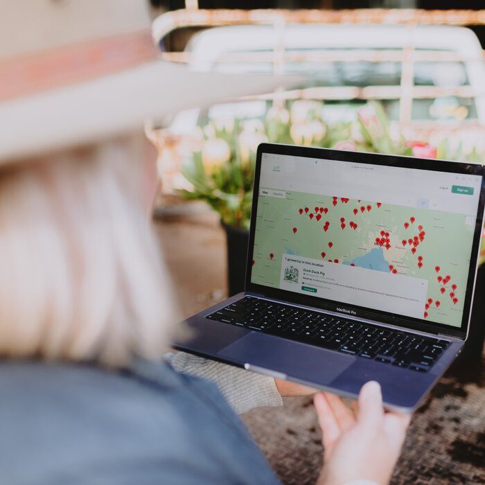 A laptop showing a map of farms on the platform